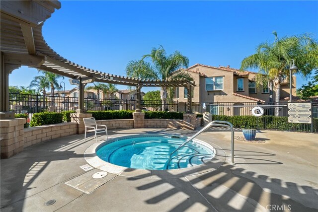 view of pool with a hot tub and a patio