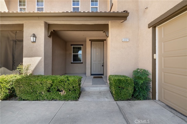 view of exterior entry with a garage