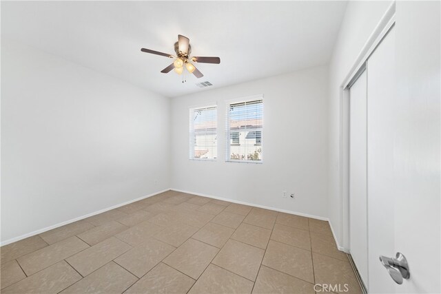 unfurnished bedroom with a closet, ceiling fan, and light tile patterned floors