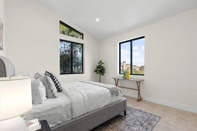 carpeted bedroom featuring vaulted ceiling