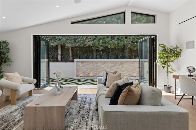 living room featuring wood-type flooring and vaulted ceiling with beams