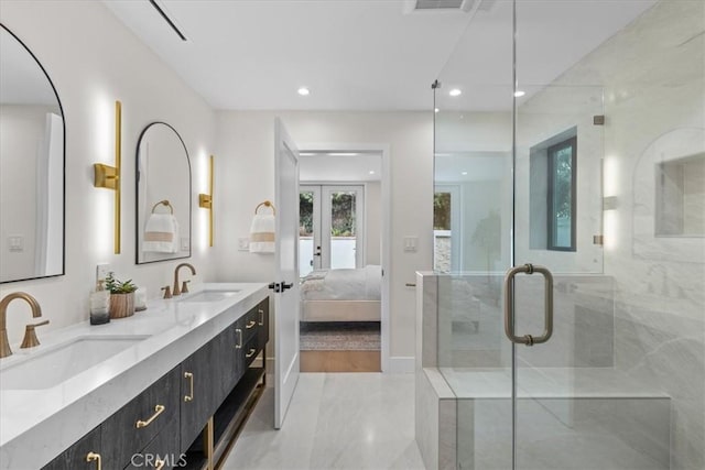 bathroom featuring vanity, french doors, and a shower with door