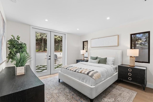 bedroom featuring wood-type flooring, access to exterior, and french doors