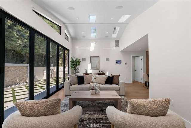 living room featuring french doors, light hardwood / wood-style flooring, and high vaulted ceiling