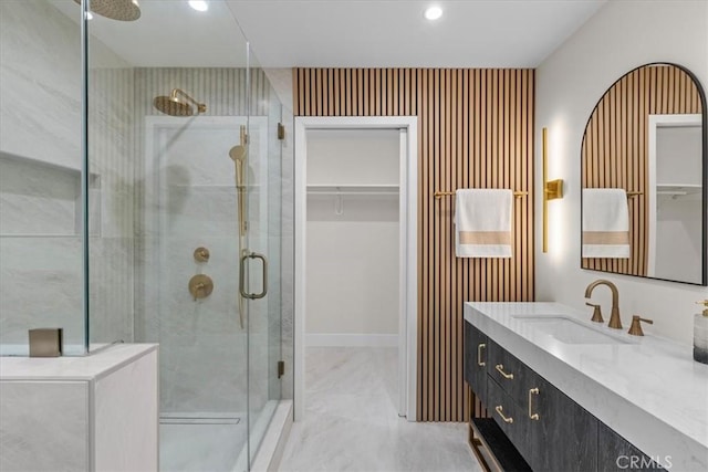 bathroom featuring walk in shower and vanity