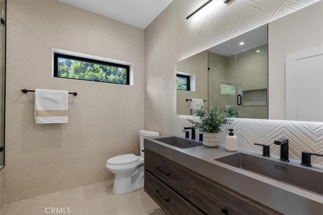 bathroom with a shower with door, toilet, tile patterned flooring, and vanity