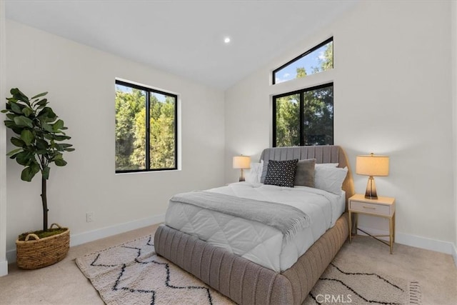 carpeted bedroom with vaulted ceiling