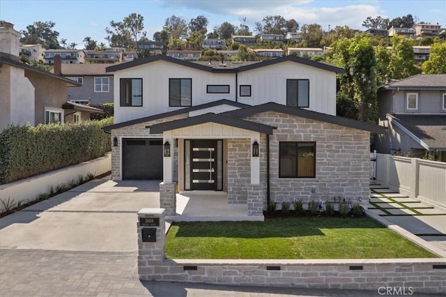 view of front of house with a garage and a front lawn