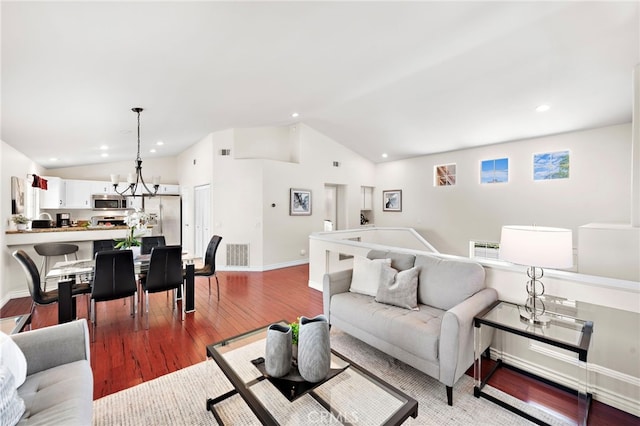 living room featuring light hardwood / wood-style floors and vaulted ceiling