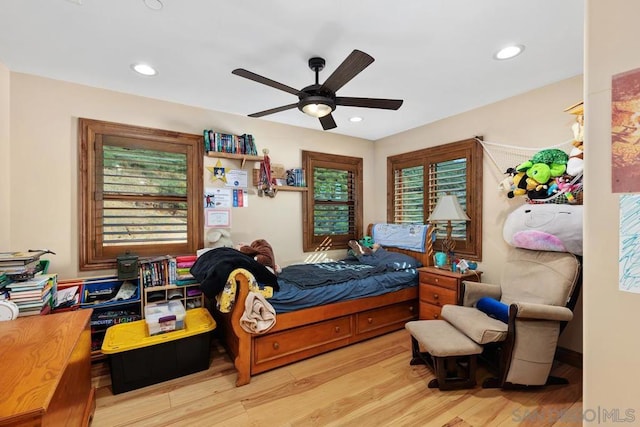 bedroom with ceiling fan and light hardwood / wood-style flooring