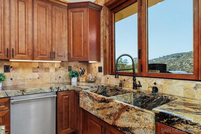 kitchen with dishwasher, decorative backsplash, stone counters, and sink