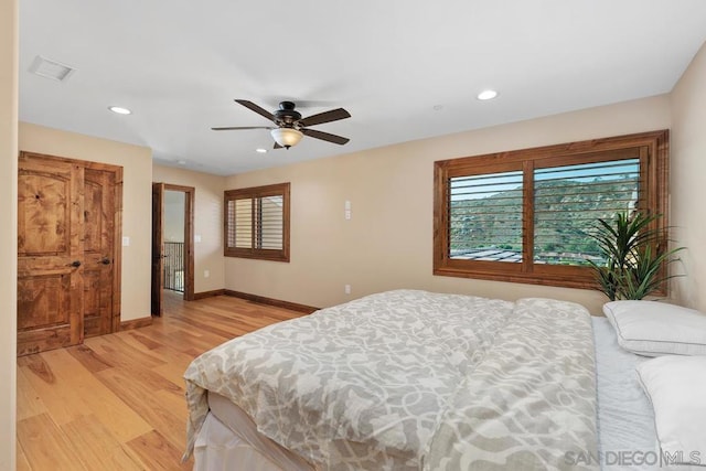 bedroom with ceiling fan and light hardwood / wood-style flooring