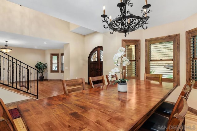 dining area featuring hardwood / wood-style floors and an inviting chandelier