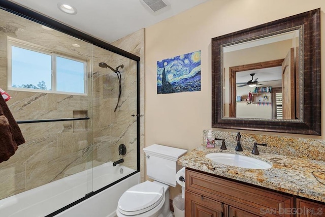 full bathroom featuring ceiling fan, vanity, toilet, and enclosed tub / shower combo