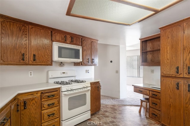 kitchen with white appliances and carpet floors