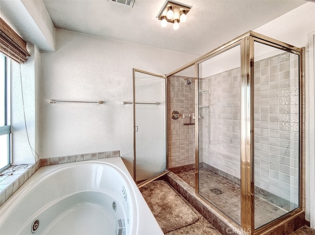 bathroom featuring a textured ceiling, plus walk in shower, and plenty of natural light