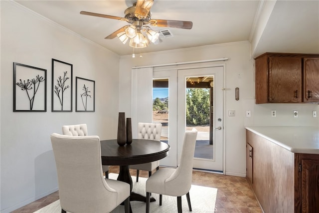 dining area with ceiling fan and ornamental molding