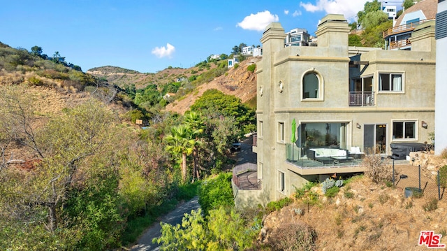 back of property with a mountain view