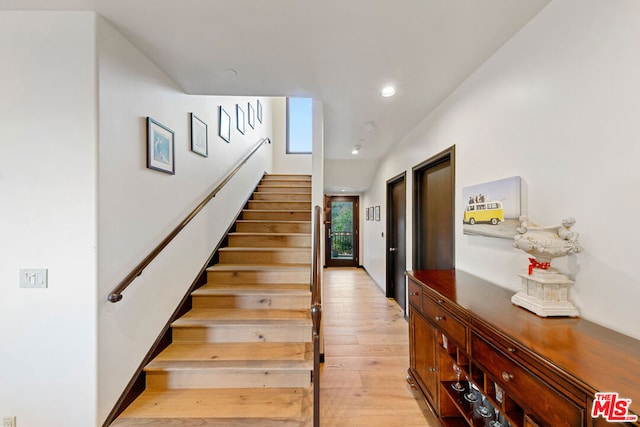 stairway with hardwood / wood-style flooring