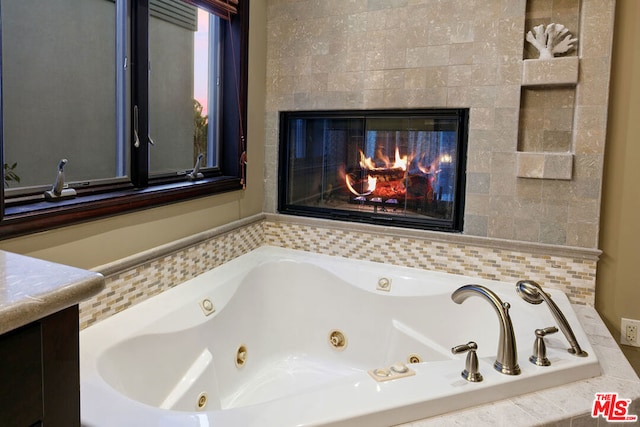 bathroom featuring tiled tub