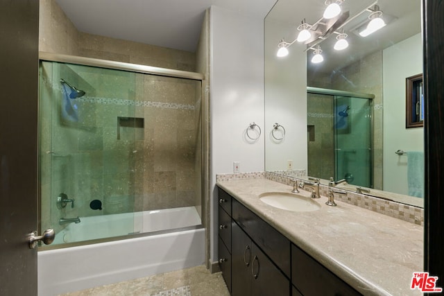 bathroom with vanity and shower / bath combination with glass door