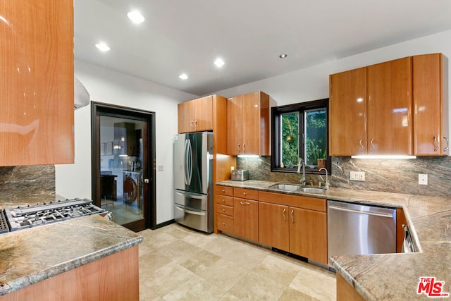 kitchen featuring decorative backsplash, sink, and appliances with stainless steel finishes