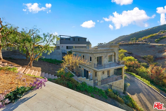 rear view of property with a balcony