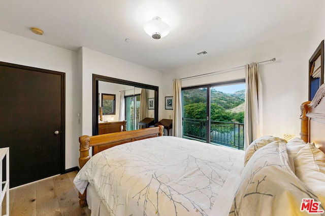 bedroom with access to exterior, a closet, and light wood-type flooring