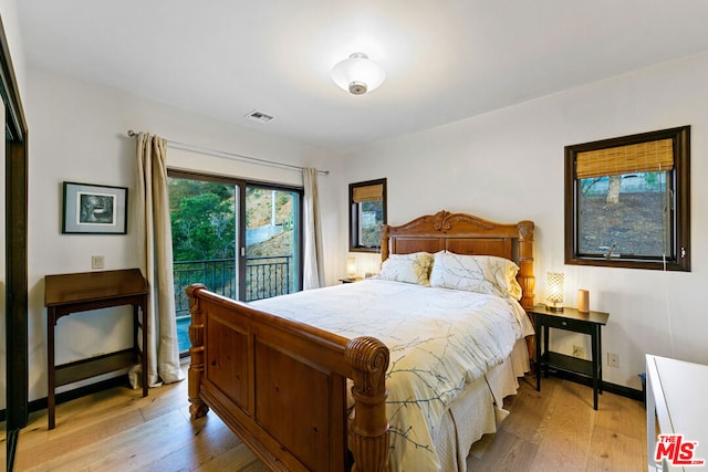 bedroom featuring access to outside and light hardwood / wood-style flooring