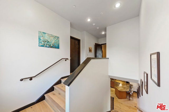 staircase featuring hardwood / wood-style flooring