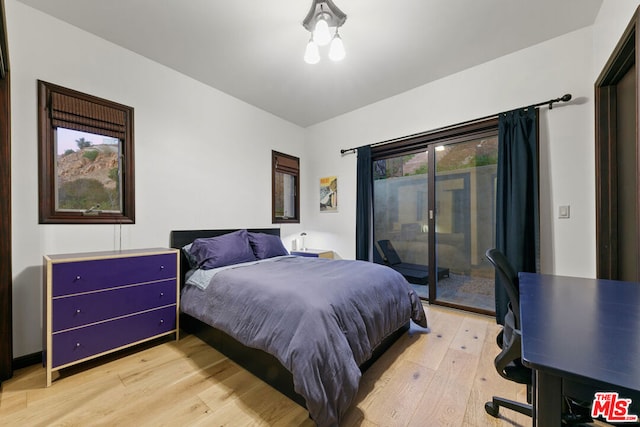 bedroom with access to exterior and light hardwood / wood-style flooring