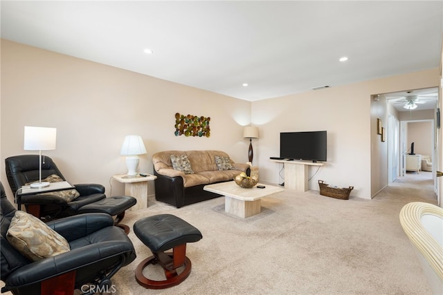 living room featuring ceiling fan and light colored carpet