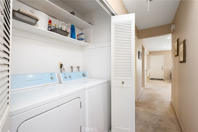 washroom featuring washing machine and clothes dryer and light colored carpet