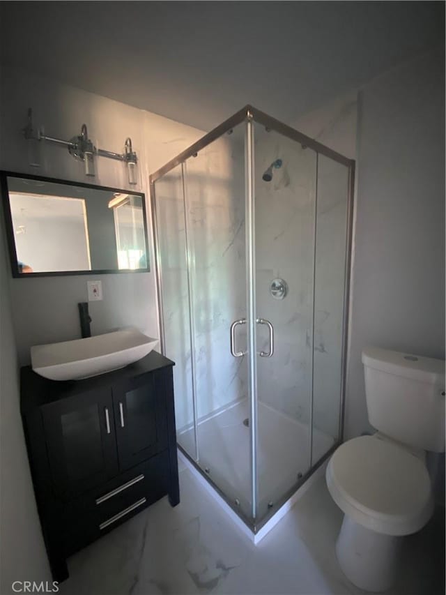 bathroom with vanity, an enclosed shower, and toilet