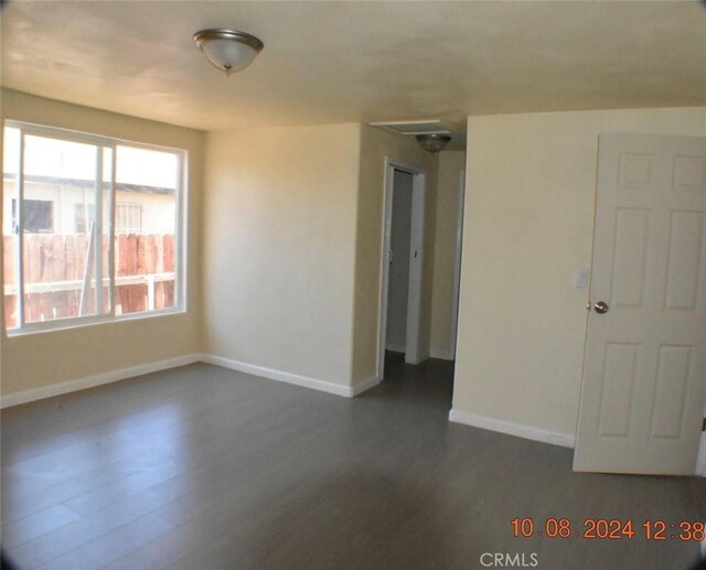 unfurnished room featuring dark hardwood / wood-style flooring