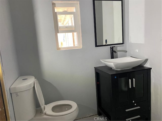 bathroom with toilet and vanity