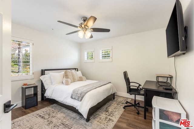 bedroom featuring ceiling fan and dark wood-type flooring