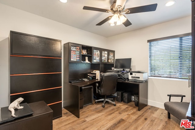 home office featuring ceiling fan and light hardwood / wood-style flooring