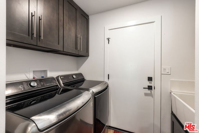 laundry area featuring cabinets and washing machine and clothes dryer