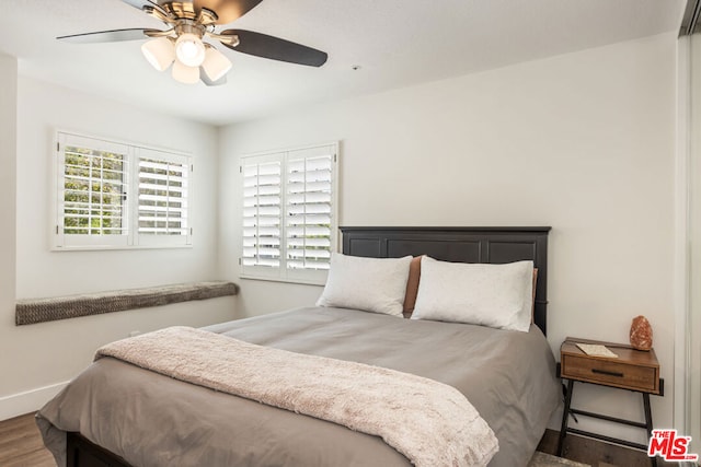 bedroom with ceiling fan and wood-type flooring