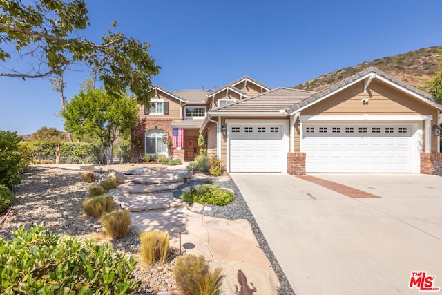 craftsman inspired home with a mountain view and a garage