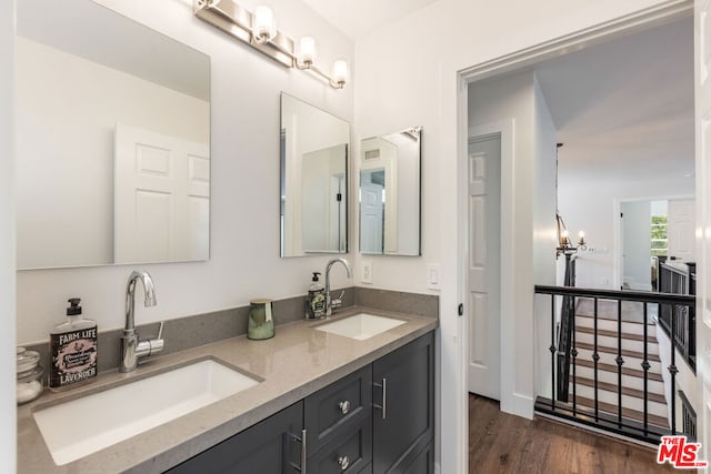 bathroom featuring vanity, wood-type flooring, and a chandelier