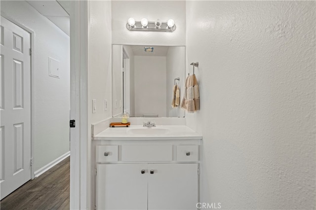 bathroom with vanity and hardwood / wood-style flooring