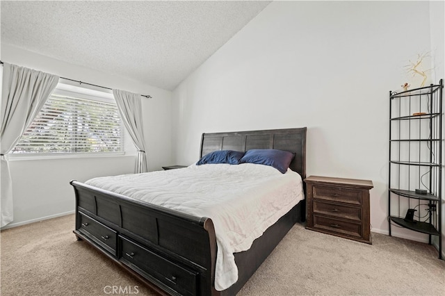 carpeted bedroom with a textured ceiling and vaulted ceiling