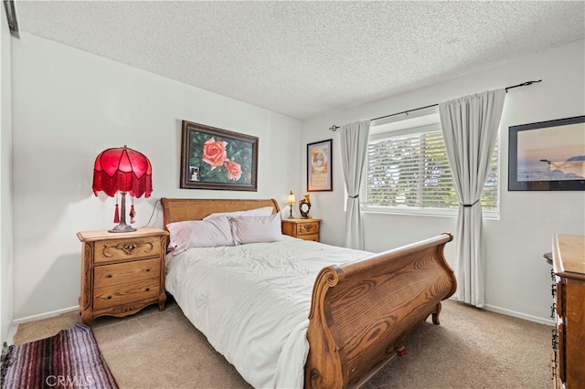 carpeted bedroom featuring a textured ceiling