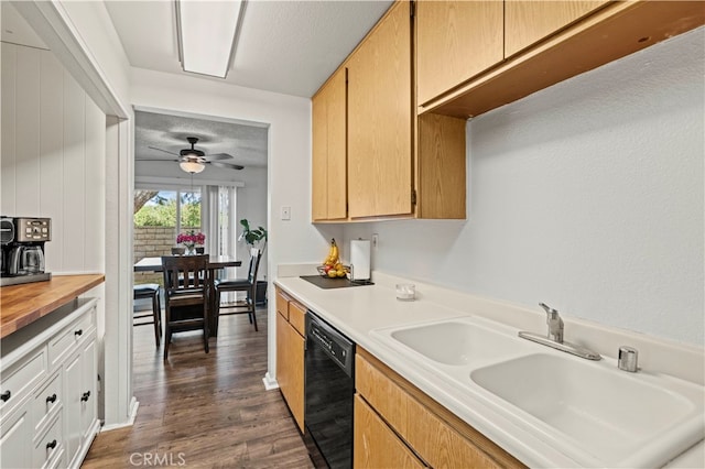 kitchen with ceiling fan, sink, a textured ceiling, dark hardwood / wood-style floors, and black dishwasher