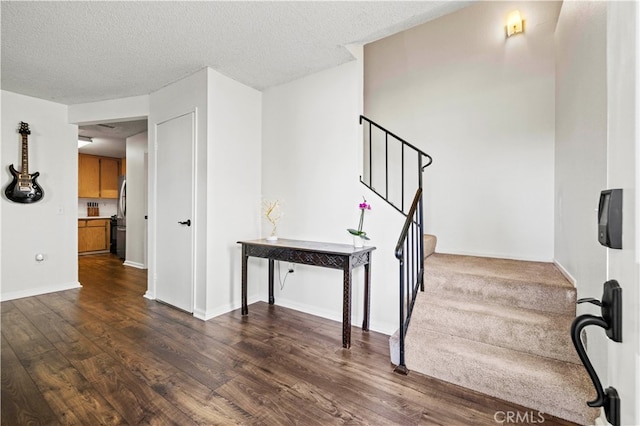 stairs featuring hardwood / wood-style flooring and a textured ceiling