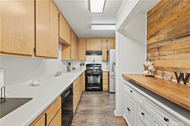 kitchen featuring light brown cabinets, dark wood-type flooring, sink, and black appliances