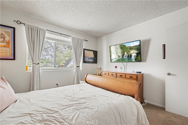 bedroom with carpet and a textured ceiling