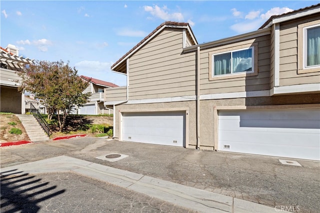 view of side of home featuring a garage